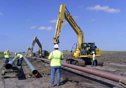 Construction workers work on a section of pipeline